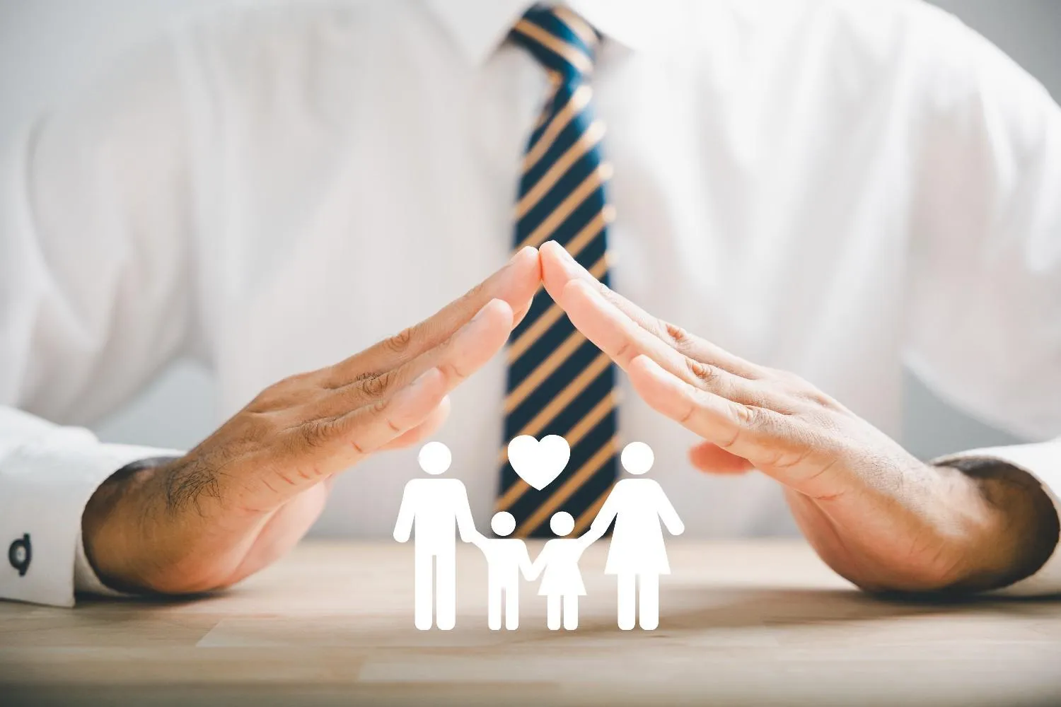 Hands forming a roof over a family symbol